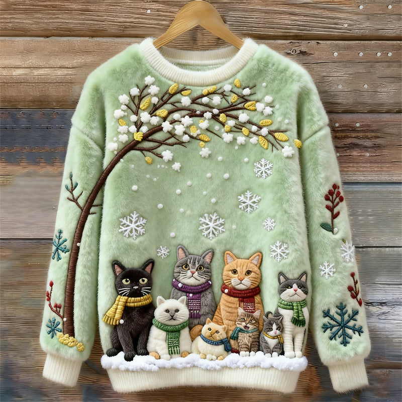 Pull en coton avec chats sous un arbre enneigé portant des écharpes