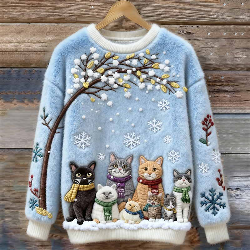 Pull en coton avec chats sous un arbre enneigé portant des écharpes
